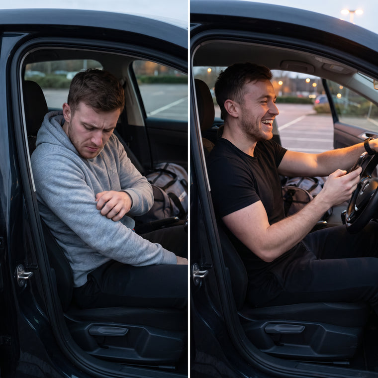 A man scratching his arm in a parked car beside a man smiling in the driving seat